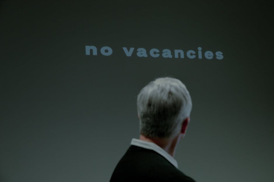 Person facing 'no vacancies' sign. Highlights job market challenges for AI-driven employment success.
