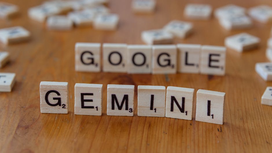 Scrabble tiles on wood spell 'GOOGLE' and 'GEMINI', representing AI chatbots redefining interaction.