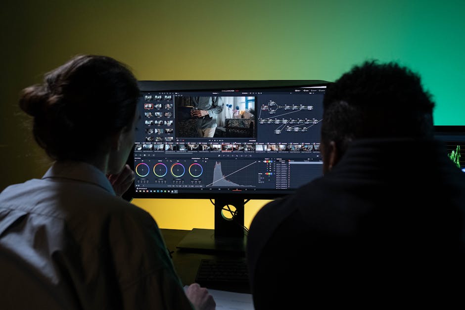 Two video editors review footage on a large monitor, using AI-powered software for post-production and color grading.