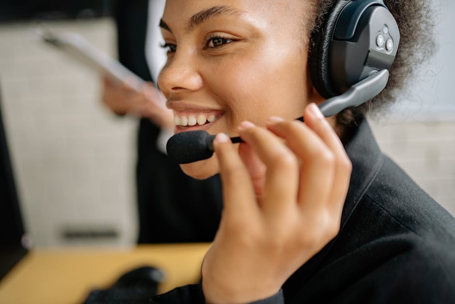 Smiling customer service agent wearing a headset with microphone, representing human interaction in AI-powered support.