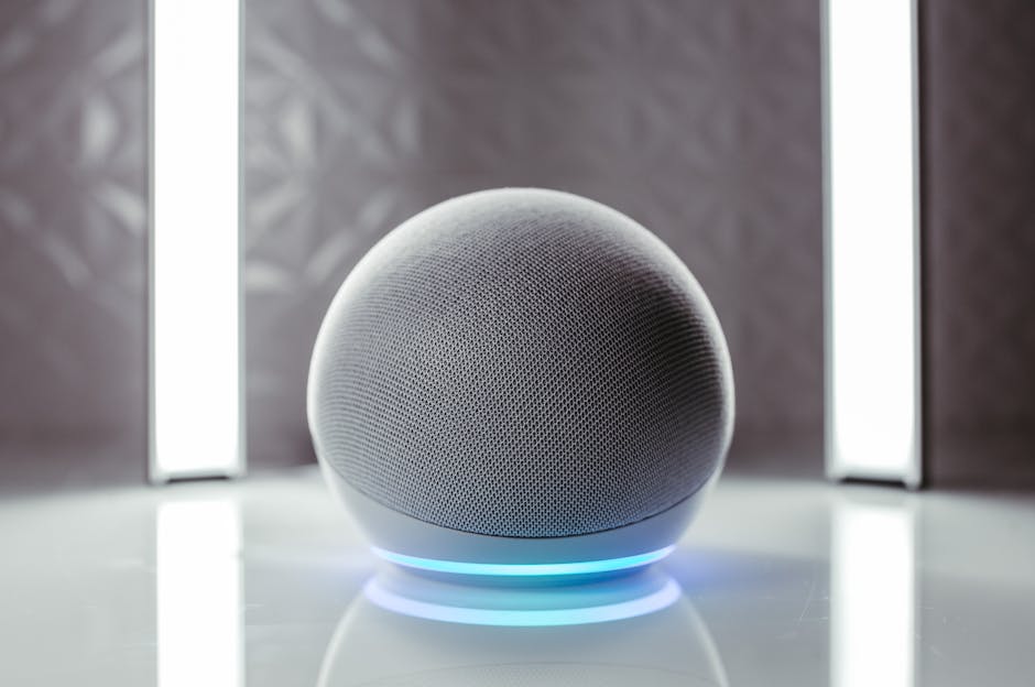 Amazon Echo AI smart speaker, gray fabric, glowing blue light on reflective surface, key to a modern smart home.