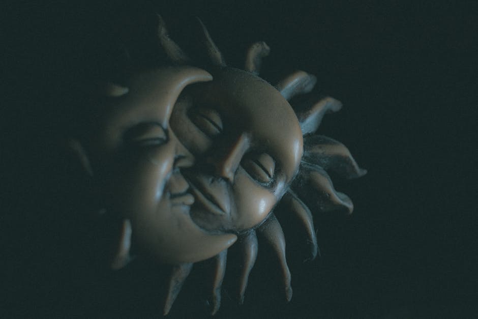 Close-up of artistic sun and moon figures, symbolizing harmonious headless CMS integration for automated sites.