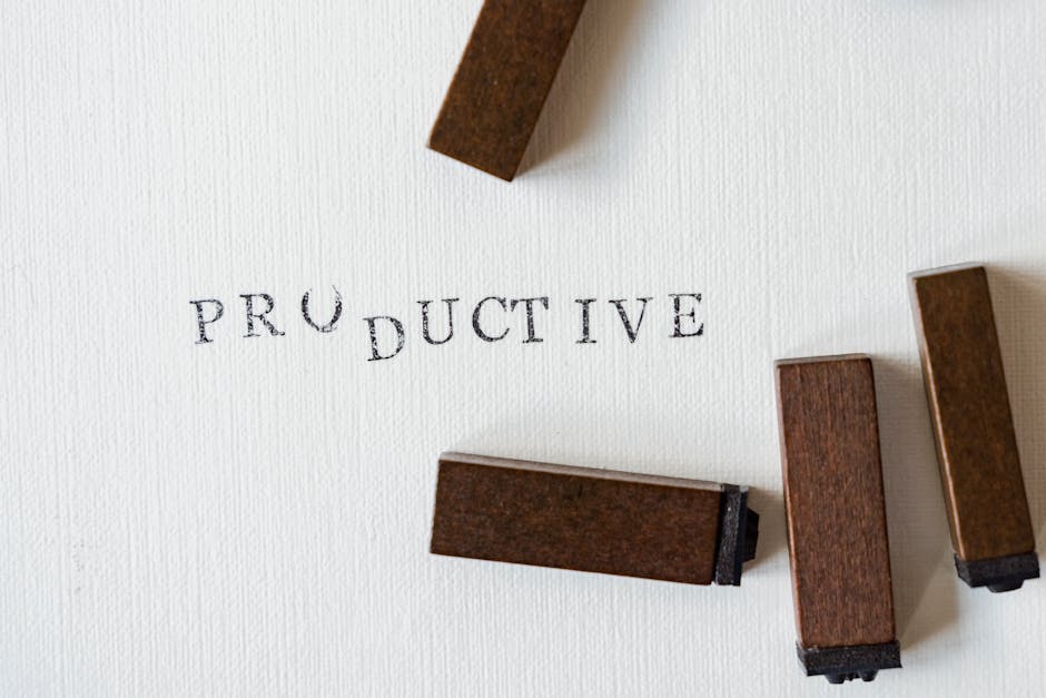 The word 'PRODUCTIVE' stamped on textured paper with letter stamps, signifying AI's role in professional email efficiency.